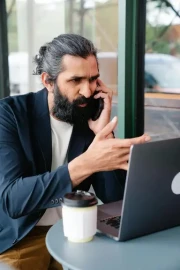 Bearded businessman having a phone call in a modern workspace