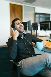 Smiling young entrepreneur sitting in a contemporary office space