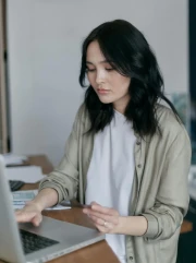 Young professional woman working on a laptop at home office