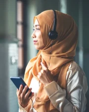 Thoughtful woman wearing a hijab looking out the window
